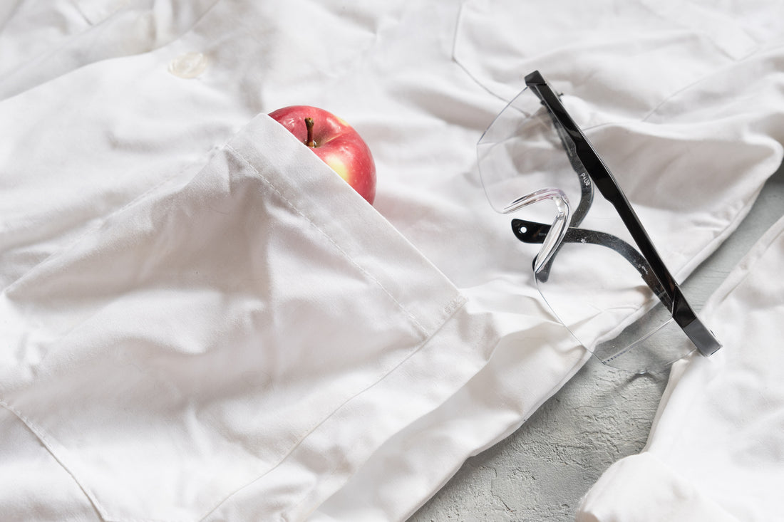 lab coat and googles with an apple in the pocket to represent intuitive eating and science
